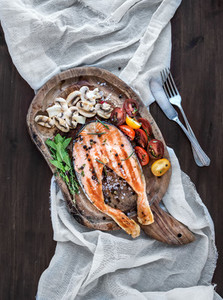 Grilled salmon steak with fresh herbs  roasted mushrooms  cherry