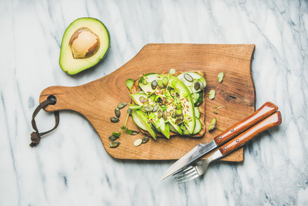 Healthy green veggie breakfast concept with sandwich on board