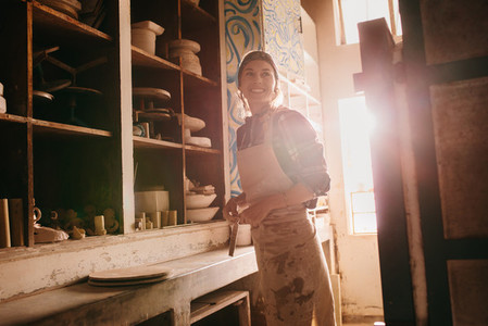 Female potter in pottery workshop