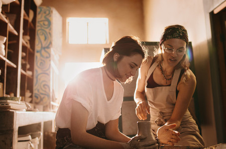 Woman teaching the art of pot making