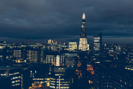 Aerial view of London skyline at night with shard building