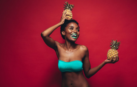 Beautiful young woman with pineapples