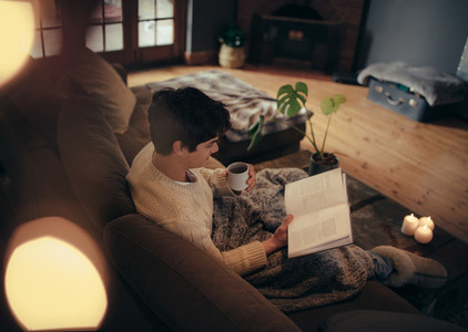 Man sitting at home and reading book