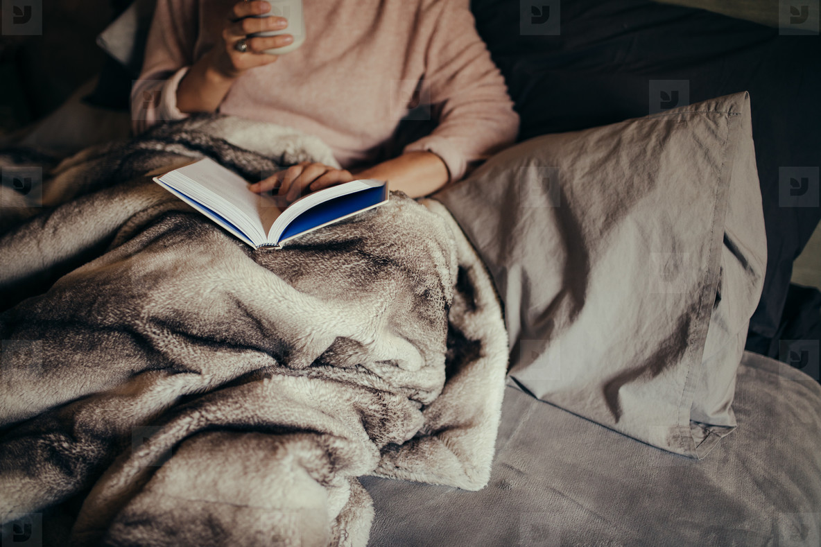 Woman on bed reading book and drinking coffee stock photo (136407) -  YouWorkForThem