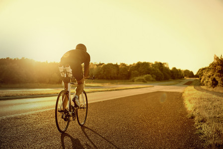 A bike rider in the evening road