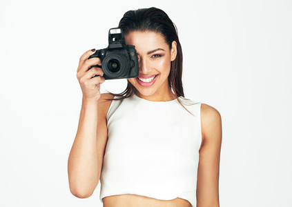Young woman holding a camera