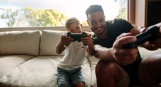 Father and son enjoying playing video game