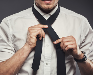 Young businessman tying his necktie for the business day