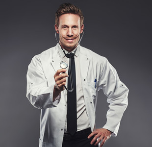 Handsome doctor with white lab coat and black tie