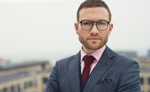 Serious intense young businessman with glasses