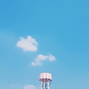 Water tower on blue sky