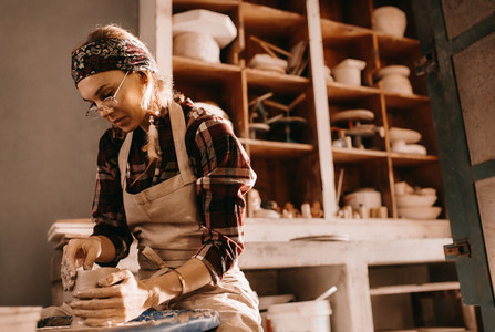 Female potter in pottery workshop