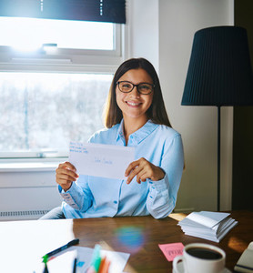Happy woman in glasses holding envelope