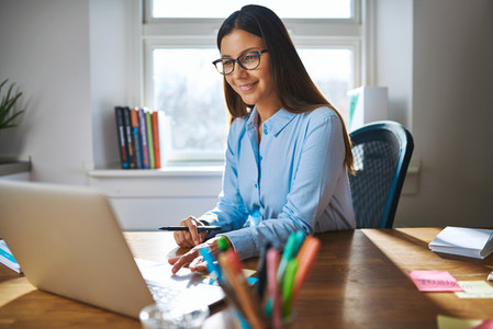 Female entrepreneur working on laptop