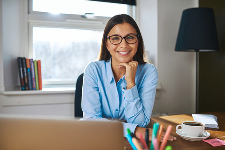 Smiling female entrepreneur at her desk