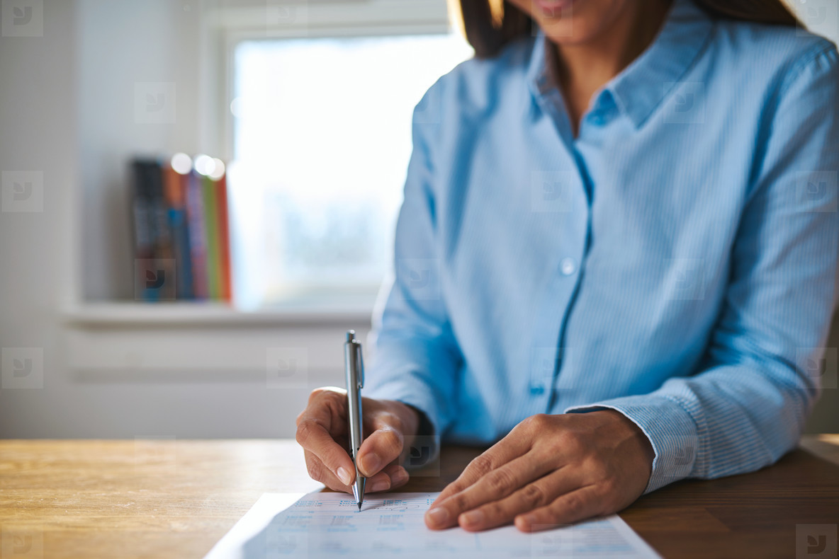 Businesswoman writing on a document