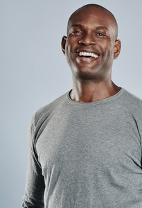 Happy man in gray shirt laughing