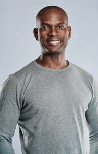 Fit handsome smiling man in gray shirt