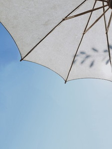 White umbrella on sunny blue sky