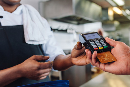 Customer making cashless payment in restaurant