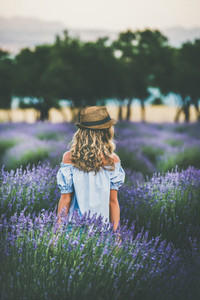 Young blond woman traveller standing in lavender field Isparta Turkey