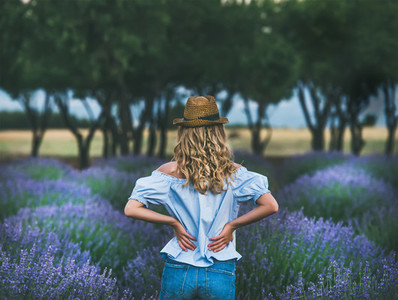 Young blond woman traveller standing in lavender field in Turkey