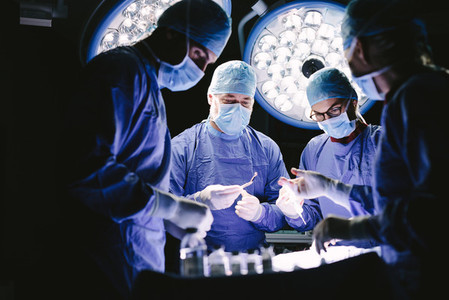 Group of medical professional performing surgery