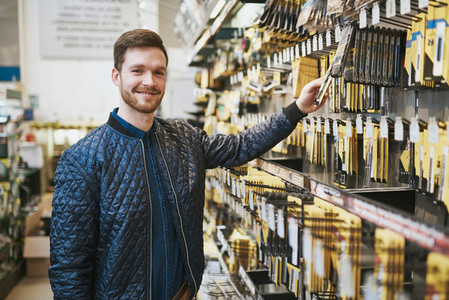Smiling confident customer in a hardware store