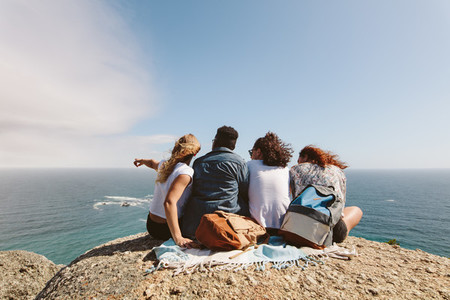 Group of friends enjoying view from top of a hill