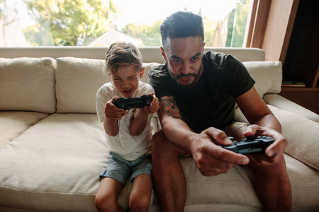 Young family having fun playing video games at home