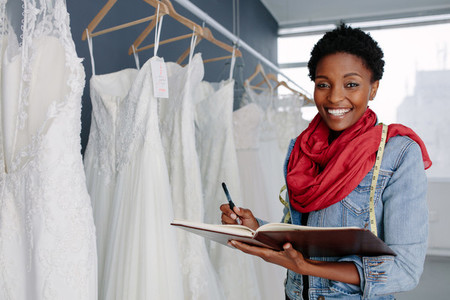 Wedding dress designer working in her boutique