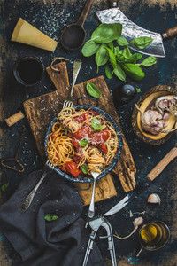 Spaghetti with tomato and basil and ingredients for making pasta