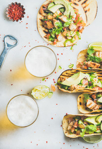 Healthy corn tortillas with chicken  vegetables and beer in glasses