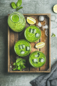 Fresh green smoothie with ice cubes mint lime in tray