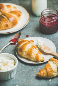 Croissants with raspberry jam  ricotta cheese and milk in bottle
