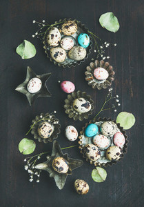 Colorful quail eggs dried wild flowers and leaves Easter celebration