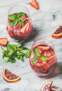 Fruit refreshing Sangria cocktails in glasses with ice and mint