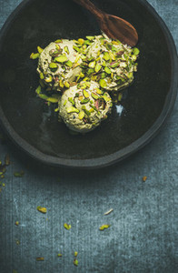 Homemade pistachio ice cream with crashed nuts in bowl