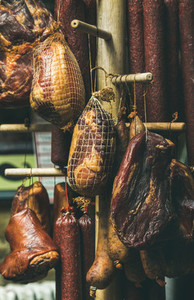 Variety of hanging traditional Hungarian smoked meat and sausages