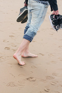 Young man walking in a beach