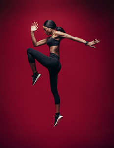 Sports woman jumping and stretching