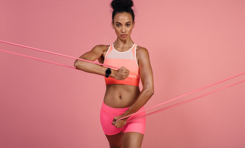 Tough woman exercising with resistance band