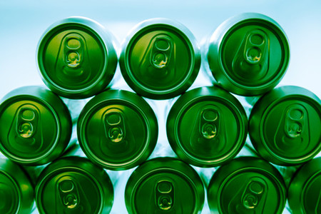 Cold green energy drinks cans in fridge at night