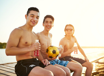 Three teenage college students at the lake