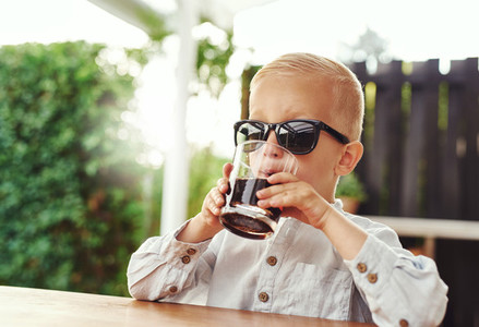 Stylish little boy wearing trendy sunglasses