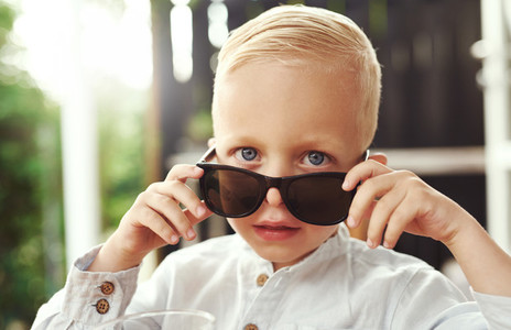 Handsome little boy in trendy sunglasses