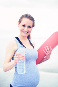Fit young woman exercising during pregnancy