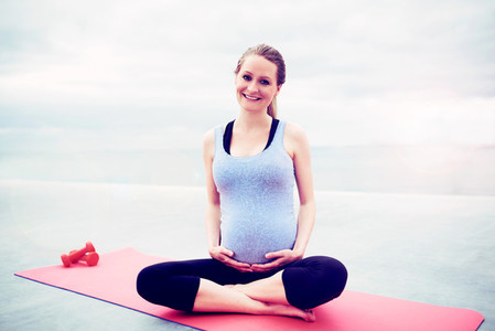 Happy woman keeping fit during her pregnancy