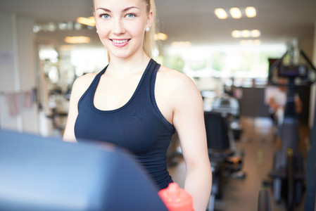 Pretty Young Woman Exercising Inside Fitness Gym