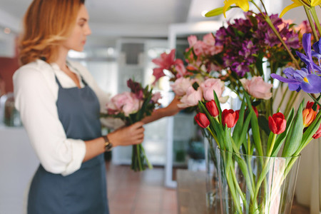 Floral design studio with florist in background